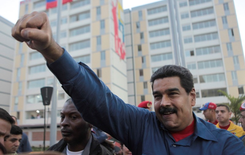 © Reuters. Venezuela's President Nicolas Maduro greets supporters as he arrives to an event for handing over houses in Caracas