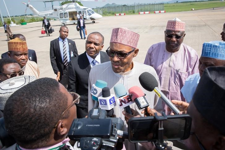 © Reuters. Nigeria's President Muhammadu Buhari speaks with the media, as he departs Abuja for London on a 10-day vacation at the Nnamdi Azikwke International Airport Abuja, Nigeria