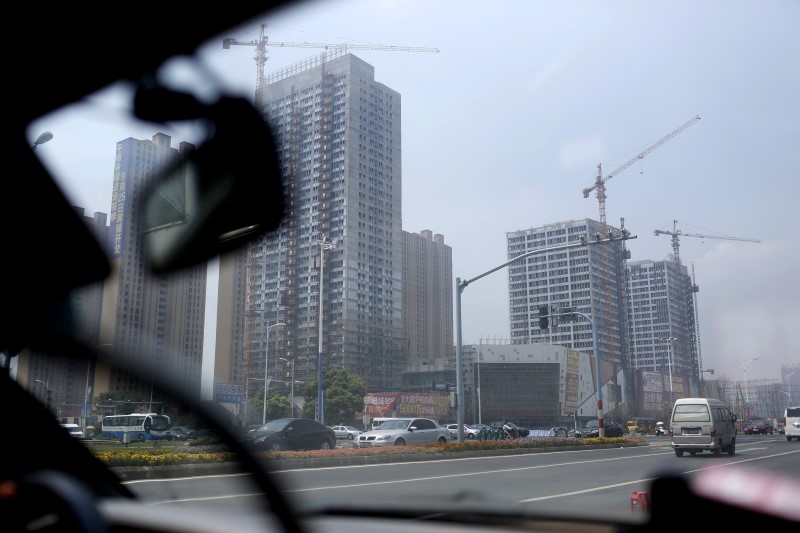 © Reuters. Residential and business buildings are seen under construction in Zhangjiagang