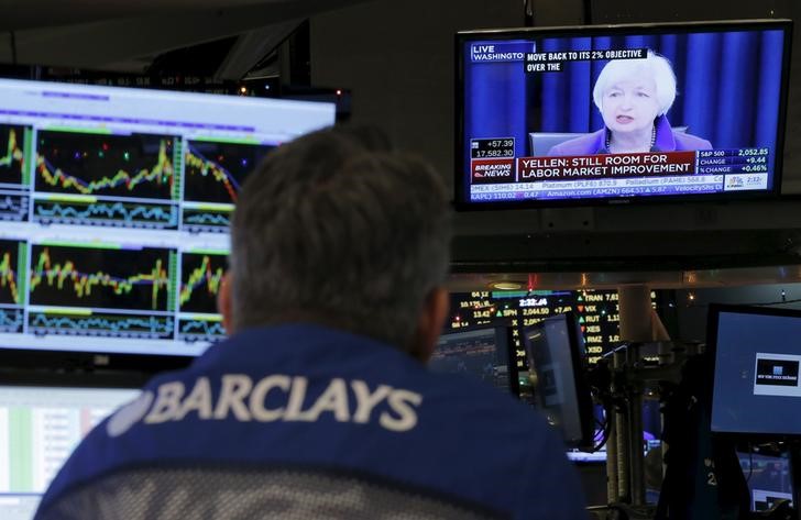 © Reuters. New York Stock Exchange trader watches announcement by Fed Chair Janet Yellen in New York