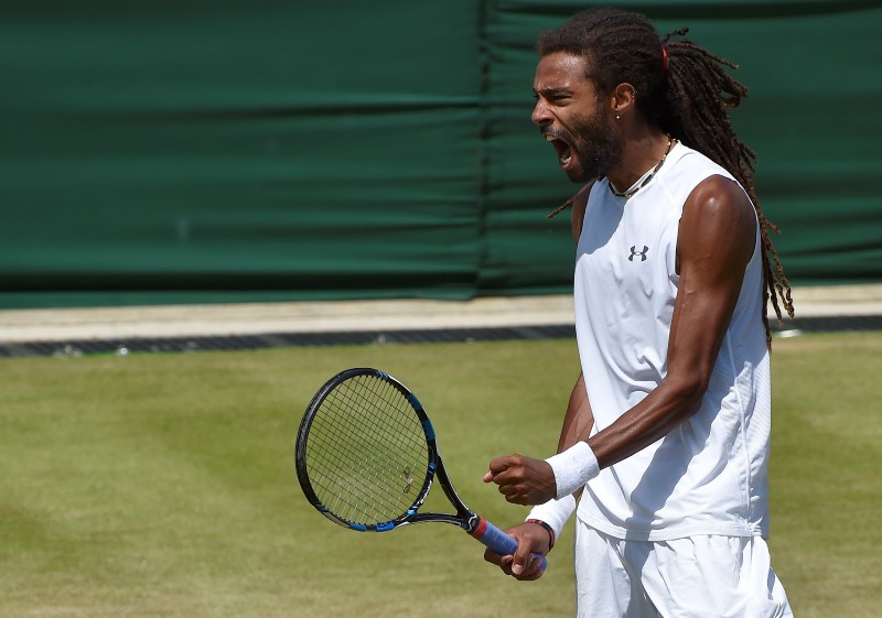 © Reuters. Dustin Brown of Germany reacts during his match against Viktor Troicki of Serbia at the Wimbledon Tennis Championships in London