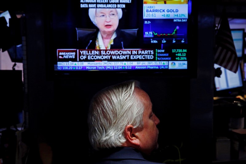 © Reuters. A trader watches Janet Yellen as he works on the floor of the NYSE