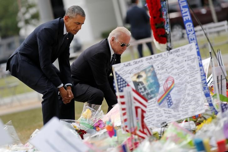 © Reuters. Presidente dos Estados Unidos, Barack Obama (E), e vice-presidente dos EUA, Joe Biden, colocam flores em memorial para as vítimas do massacre em uma boate gay em Orlando