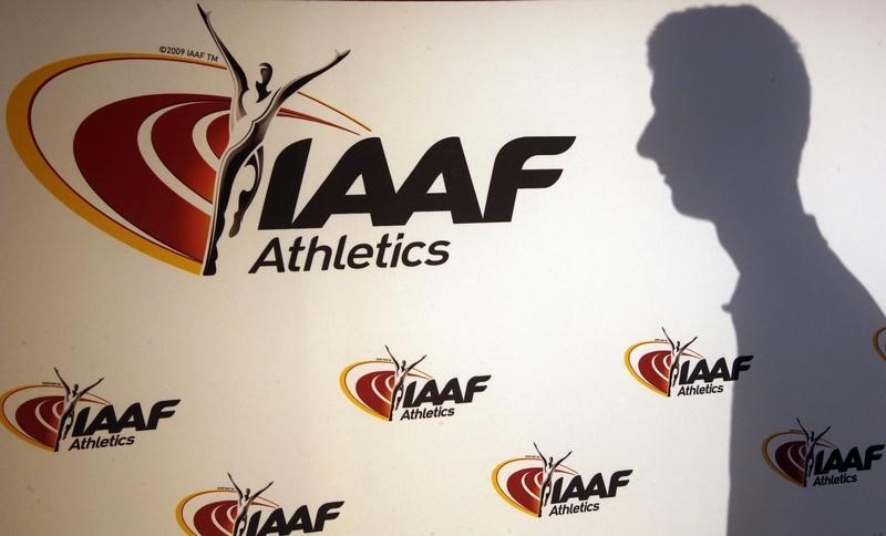 © Reuters. A man casts his shadow following a press conference by Sebastian Coe, IAAF's President, as part of the 203nd International Association of Athletics Federations (IAAF) council meeting  in Monaco