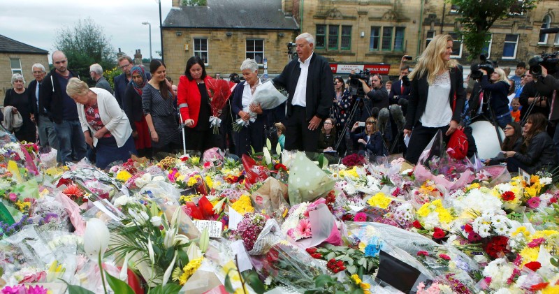© Reuters. The parents of murdered Labour Party MP Jo Cox, Gordon and Jean Leadbeater and her sister Kim look at floral tributes left in Birstall
