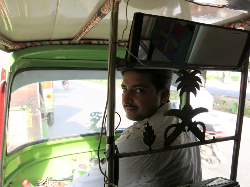 © Reuters. Rixi rickshaw driver Saeed Akhtar sits in his rickshaw in Lahore