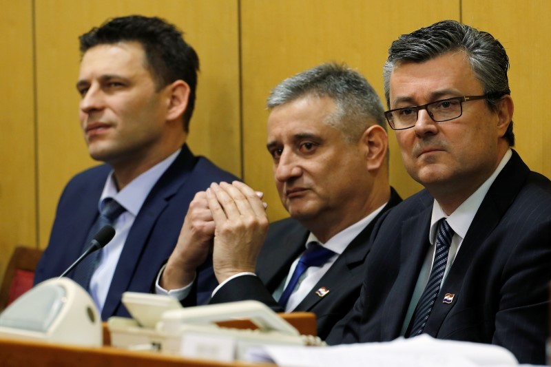© Reuters. Croatia's Prime Minister-designate Tihomir Oreskovic, new First Deputy Prime Minister Tomislav Karamarko and new Deputy Prime Minister Bozo Petrov seek approval for the new government in the parliament in Zagreb