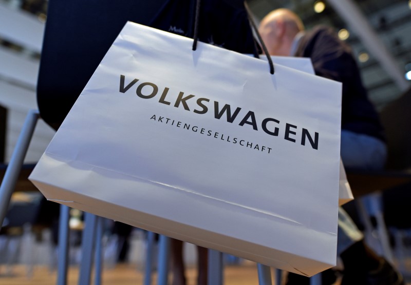 © Reuters. A Volkswagen shareholder carries a bag at the annual shareholder meeting in Hanover