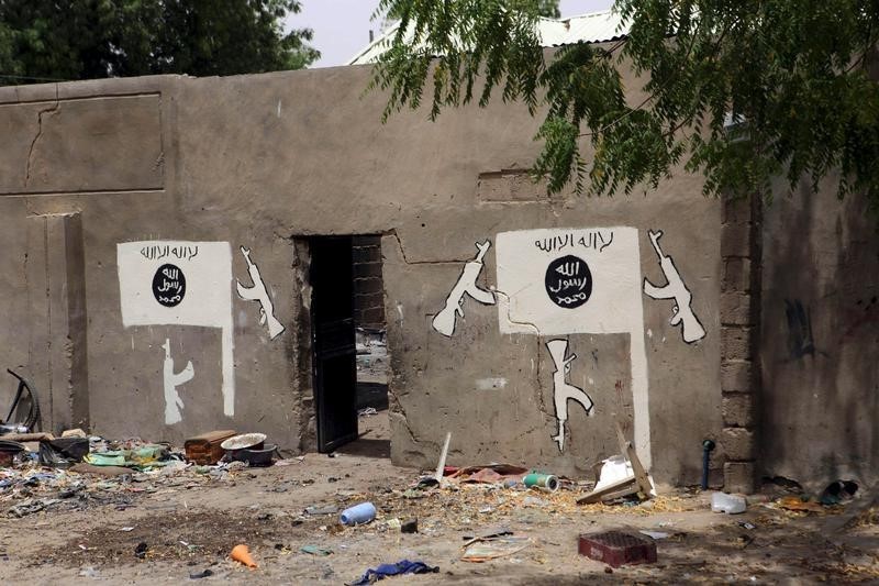 © Reuters. A wall painted by Boko Haram is pictured in Damasak