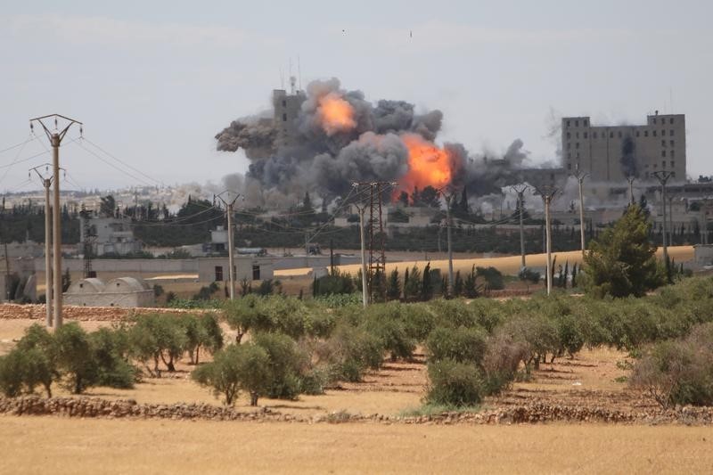 © Reuters. Smoke and flame rise after what fighters of the Syria Democratic Forces (SDF) said were U.S.-led air strikes on the mills of Manbij where Islamic State militants are positioned,  in Aleppo Governorate