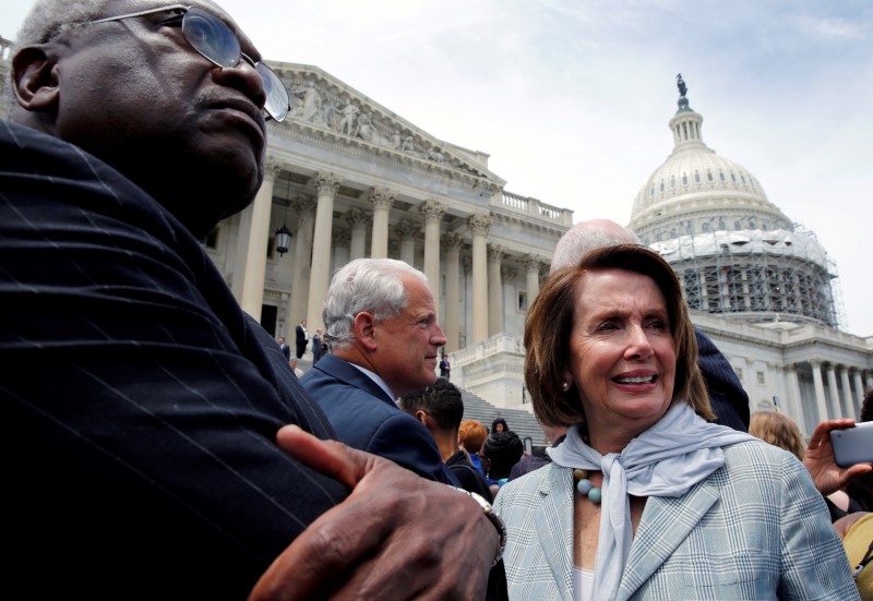 © Reuters. U.S. House Minority Leader Nancy Pelosi (D-CA) and Rep. James Clyburn (D-SC) walk out with House Democrats on Capitol Hill in Washington