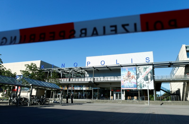 © Reuters. Warning tape is pictured in front of a cinema complex after a masked man with a gun and ammunition belt opened fire in Viernheim