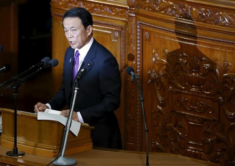 © Reuters. Aso speaks during the lower house session of the parliament in Tokyo