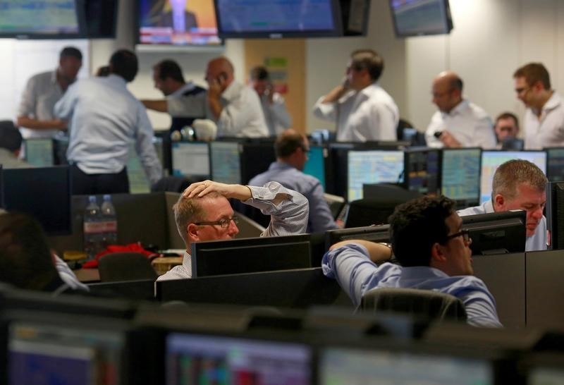 © Reuters. Traders from BGC, a global brokerage company in London's Canary Wharf financial centre react as European stock markets open