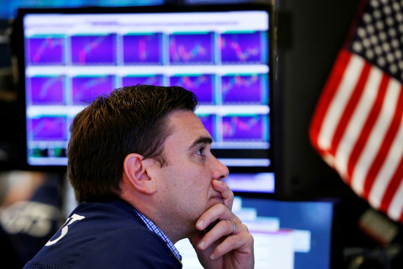 © Reuters. A trader works on the floor of the New York Stock Exchange (NYSE) after the opening bell in New York