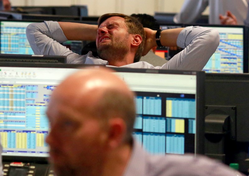 © Reuters. A trader from BGC, a global brokerage company in London's Canary Wharf financial centre reacts during trading