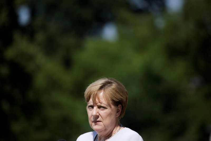 © Reuters. German Chancellor Merkel briefs the media prior to a meeting with German government's Social Partners, leaders of labor unions and employer organization, at the government guest house Meseberg Palace in the village Meseberg