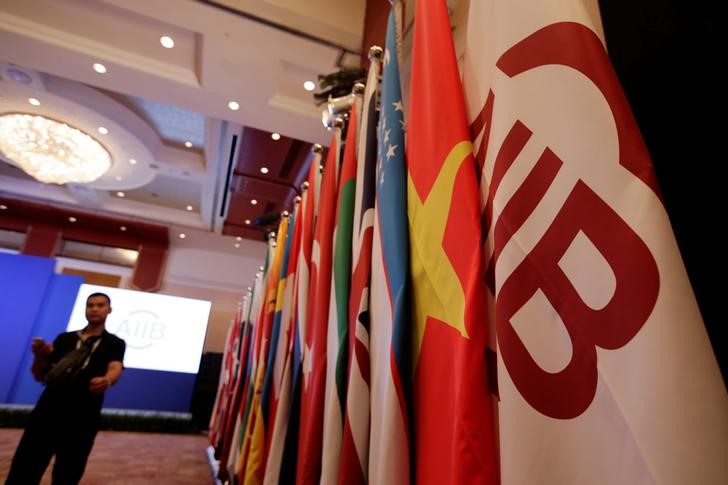 © Reuters. Flags of AIIB and member states are set up for the opening ceremony of the first annual meeting of AIIB in Beijing