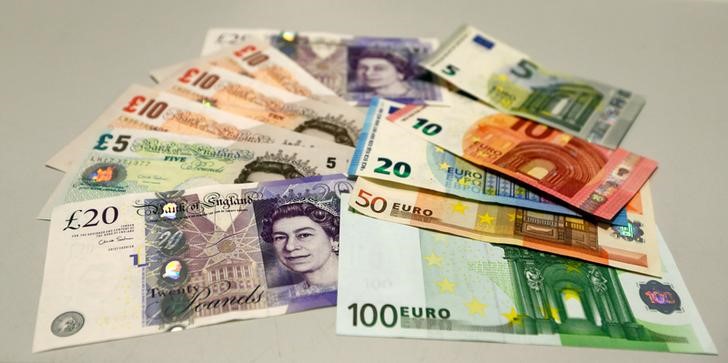 © Reuters. British pounds and Euro banknotes are pictured in a bank at main train station in Munich