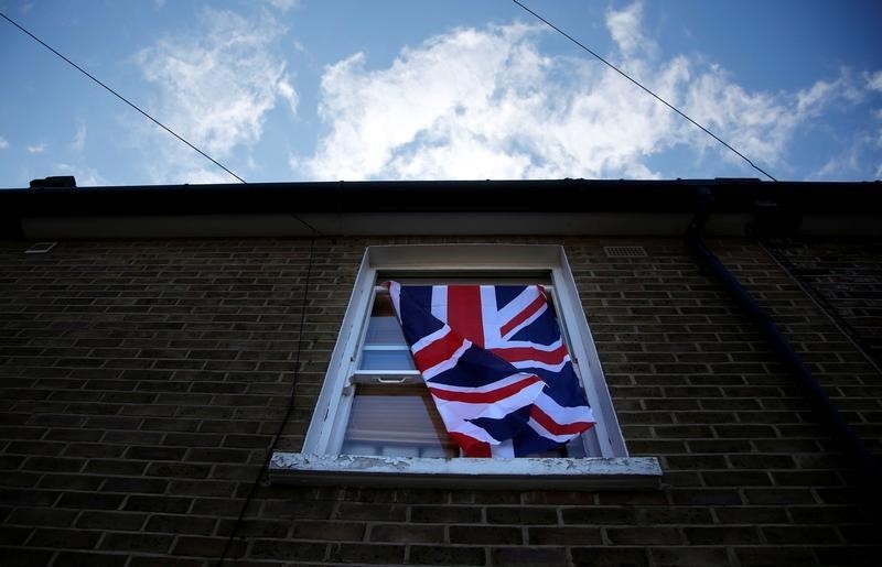 © Reuters. A British flag flutters in front of a window in London,