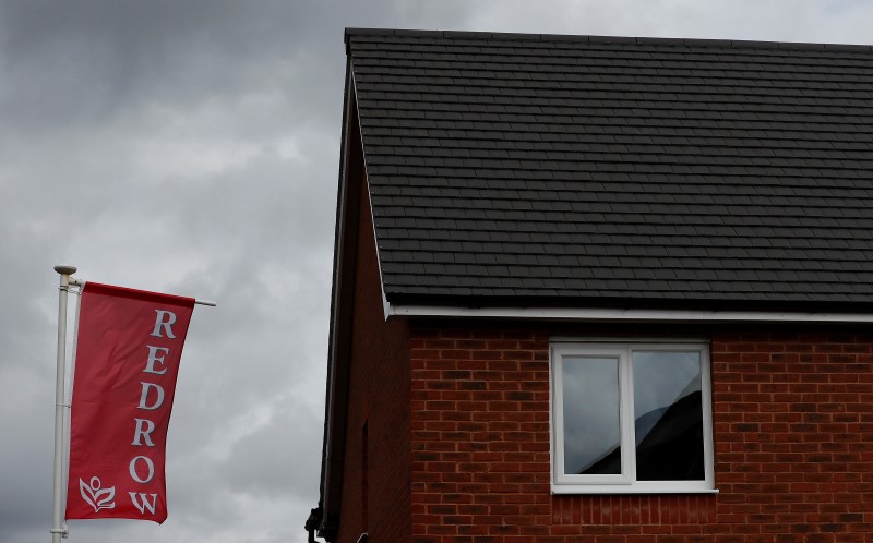 © Reuters. The company logo of construction company Redrow is pictured on a flag at a new housing development near Manchester northern England.