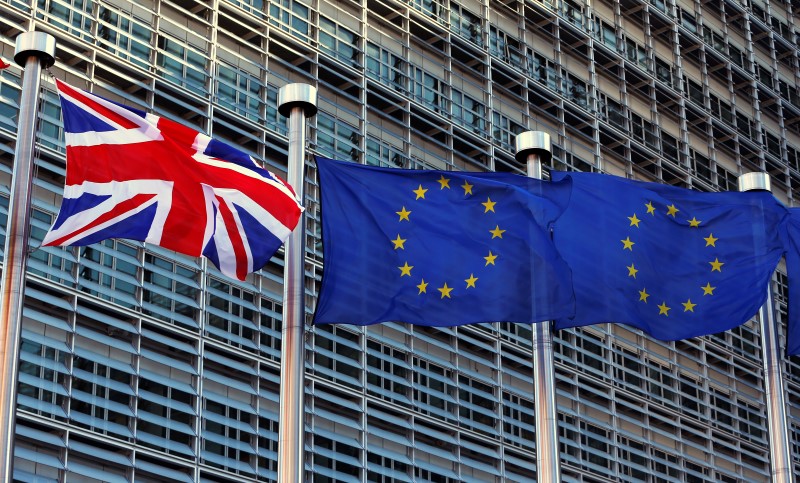 © Reuters. A Union Jack flag flutters next to European Union flags ahead of a visit from Britain's PM Cameron at the EU Commission headquarters in Brussels