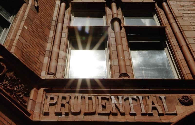 © Reuters. The sun reflects in a window above the raised lettering of the former Prudential Assurance building in the City of London