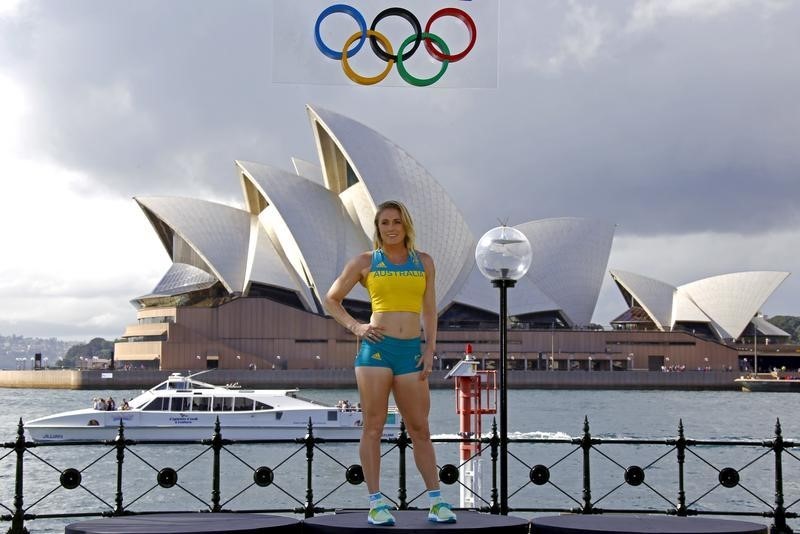 © Reuters. Australian Olympic team member Pearson poses  in front of the Sydney Harbour Bridge during the official launch of the team uniforms for the 2016 Rio Olympics