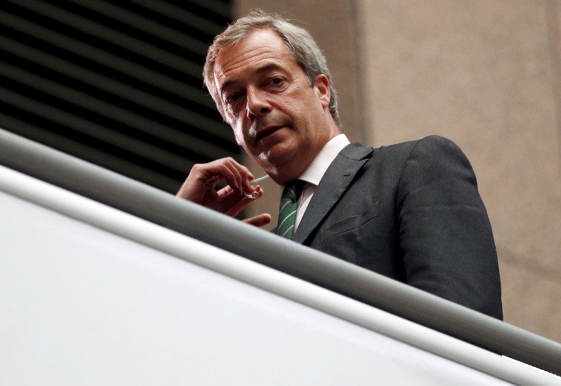 © Reuters. The leader of the United Kingdom Independence Party Farage looks on as he waits for TV interview during the EU Summit in Brussels