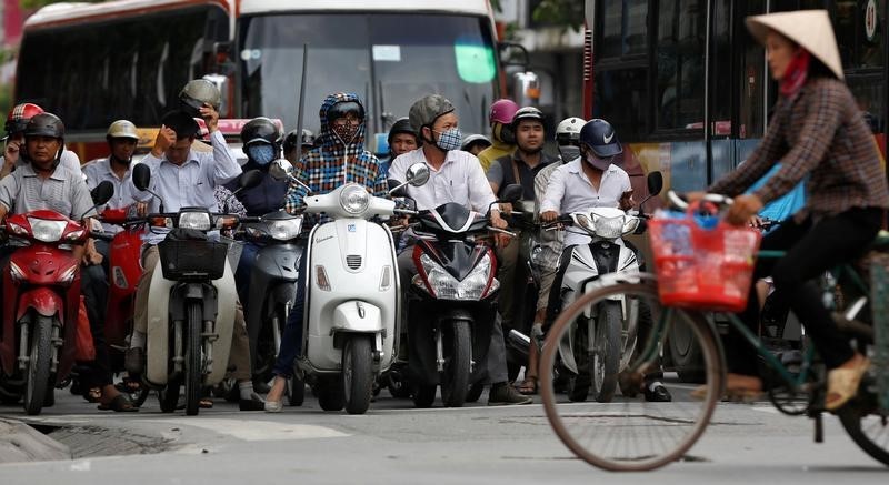 © Reuters. Motorcycles are seen on a street in Hanoi