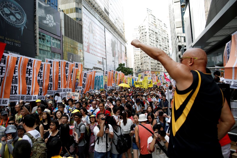 © Reuters. Lawmaker Albert Chan Wai-yip shouts during a protest march on the day marking the 19th anniversary of Hong Kong's handover to Chinese sovereignty from British rule, in Hong Kong, China