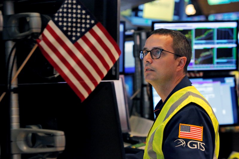 © Reuters. A trader works on the floor at the New York Stock Exchange in New York City