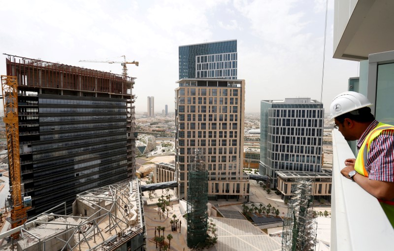 © Reuters. Man views the under-construction King Abdullah Financial District in Riyadh