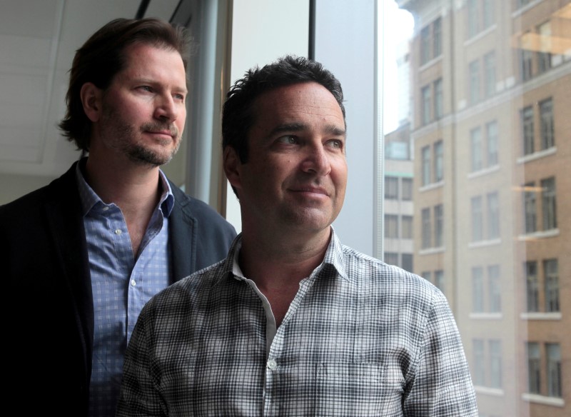 © Reuters. Online dating agency Ashley Madison's CEO Rob Segal and president James Millership pose during an interview in Toronto