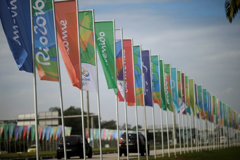 © Reuters. Flags with welcome messages in several languages advertising the 2016 Rio Olympics are pictured on Rio de Janeiro's international airport driveway