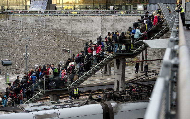 © Reuters. Police organize a line of refugees on a stairway leading up to trains arriving from Denmark at the Hyllie train station outside Malmo