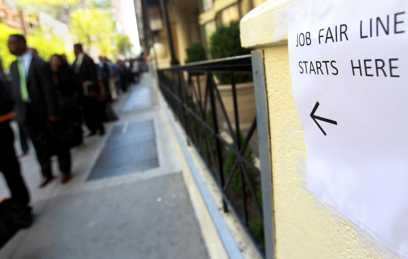 © Reuters. People wait in line to enter a job fair in New York