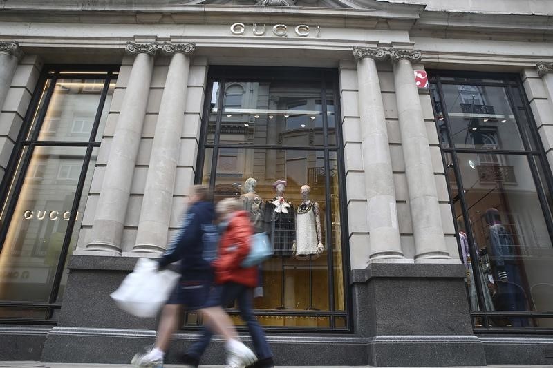 © Reuters. People pass a Gucci store on Old Bond Street in London