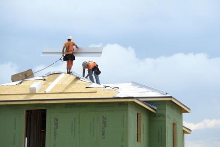 © Reuters. Workers construct a new home in the Balmoral neighborhood being developed by Irishman Garrett Kenny