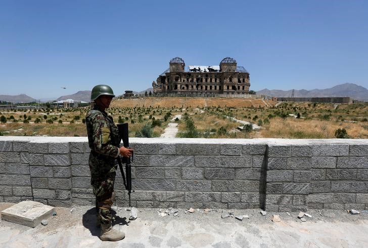 © Reuters. An Afghan National Army soldier stands guard after the inauguration of the reconstruction project to restore the ruins of historic Darul Aman palace, in Kabul