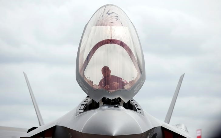 © Reuters. A ground crew member works in the cockpit of a US Marine Corps Lockheed Martin F-35B fighter jet at the Royal International Air Tattoo at Fairford