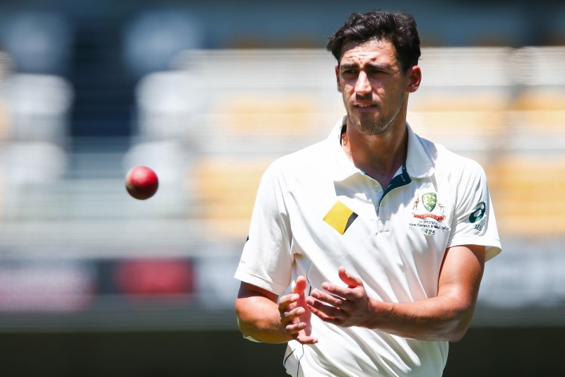 © Reuters. Australian bowler Mitchell Starc receives the ball, during the first cricket test match between Australia and New Zealand in Brisbane