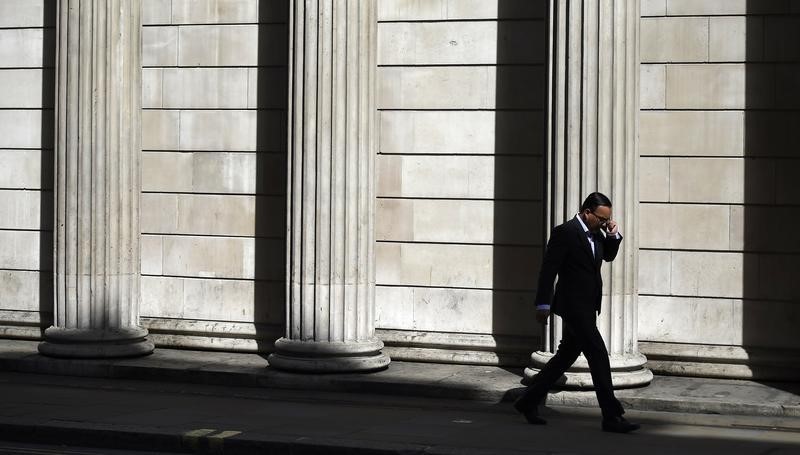 © Reuters. A man speaks on his phone outside the Bank of England in London