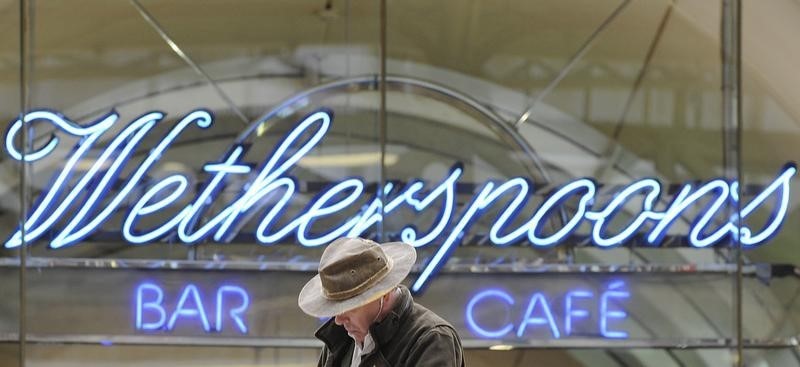 © Reuters. A Wetherspoon's logo is seen at a bar in central London