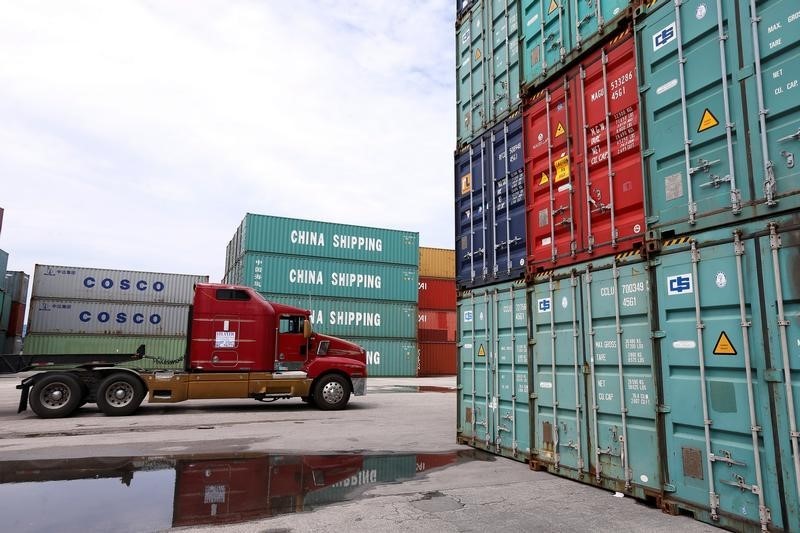 © Reuters. A truck drives past a stack of China Shipping shipping containers in the Port of Miami in Miami