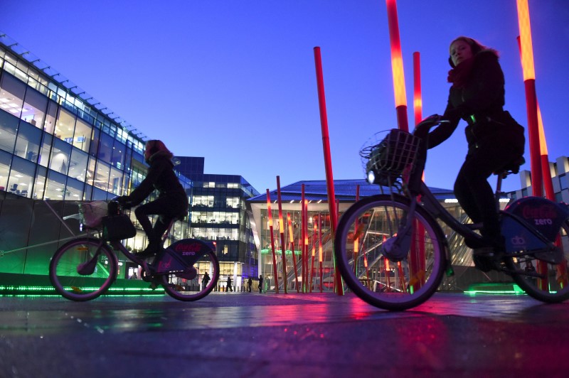 © Reuters. Cyclists ride dublinbikes in Dublin's docklands area