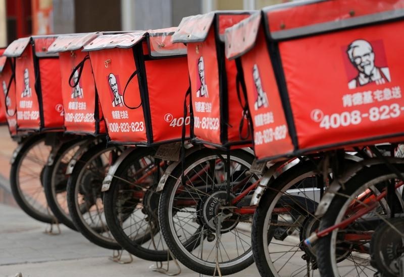 © Reuters. Logos of KFC, owned by Yum Brands Inc, are seen on its delivery bicycles in front of its restaurant in Beijing