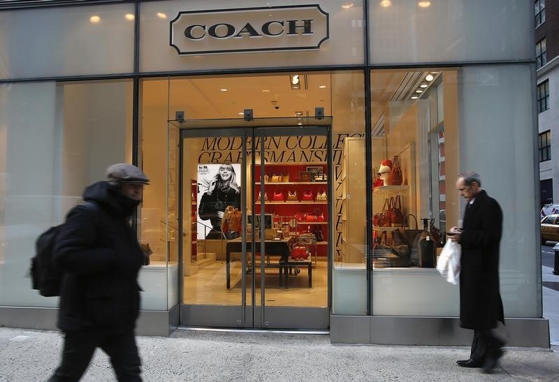 © Reuters. People walk past a Coach store on Madison Avenue in New York
