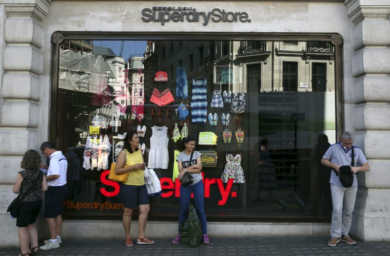 © Reuters. People stand outside a Superdry store in central London