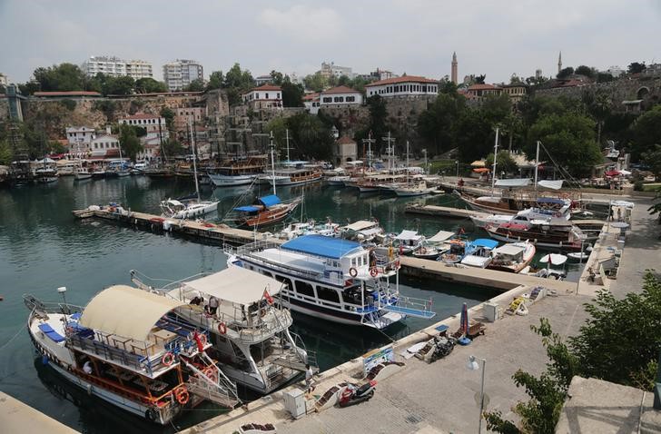 © Reuters. Tourists boats are seen in the harbour of the old city center of the Mediterranean resort city of Antalya